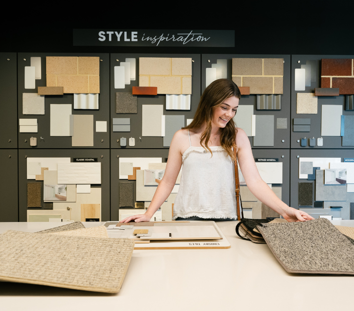 How to cut costs when building a house - choose cost effective selections, lady in front of carpet selections 