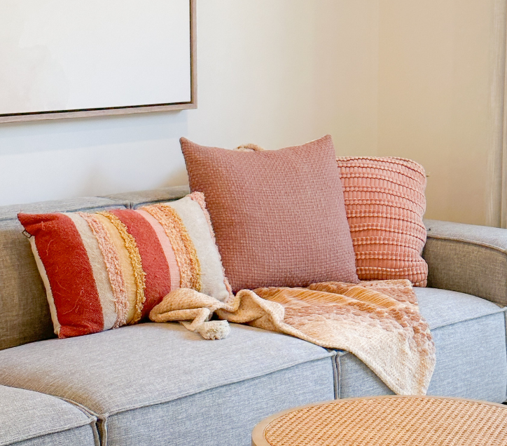 Cosy living room setup with coordinated cushions and throws adding soft texture to the space.
